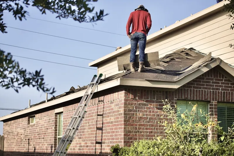Professional roofer working on a residential roof in North Syracuse